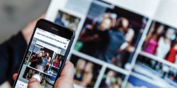 A person using yearbook plus by scanning their yearbook photo with their phone.