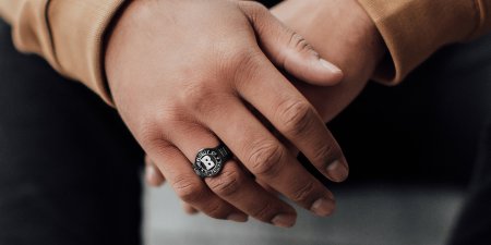 A soon-to-be graduating student shows their college class ring.